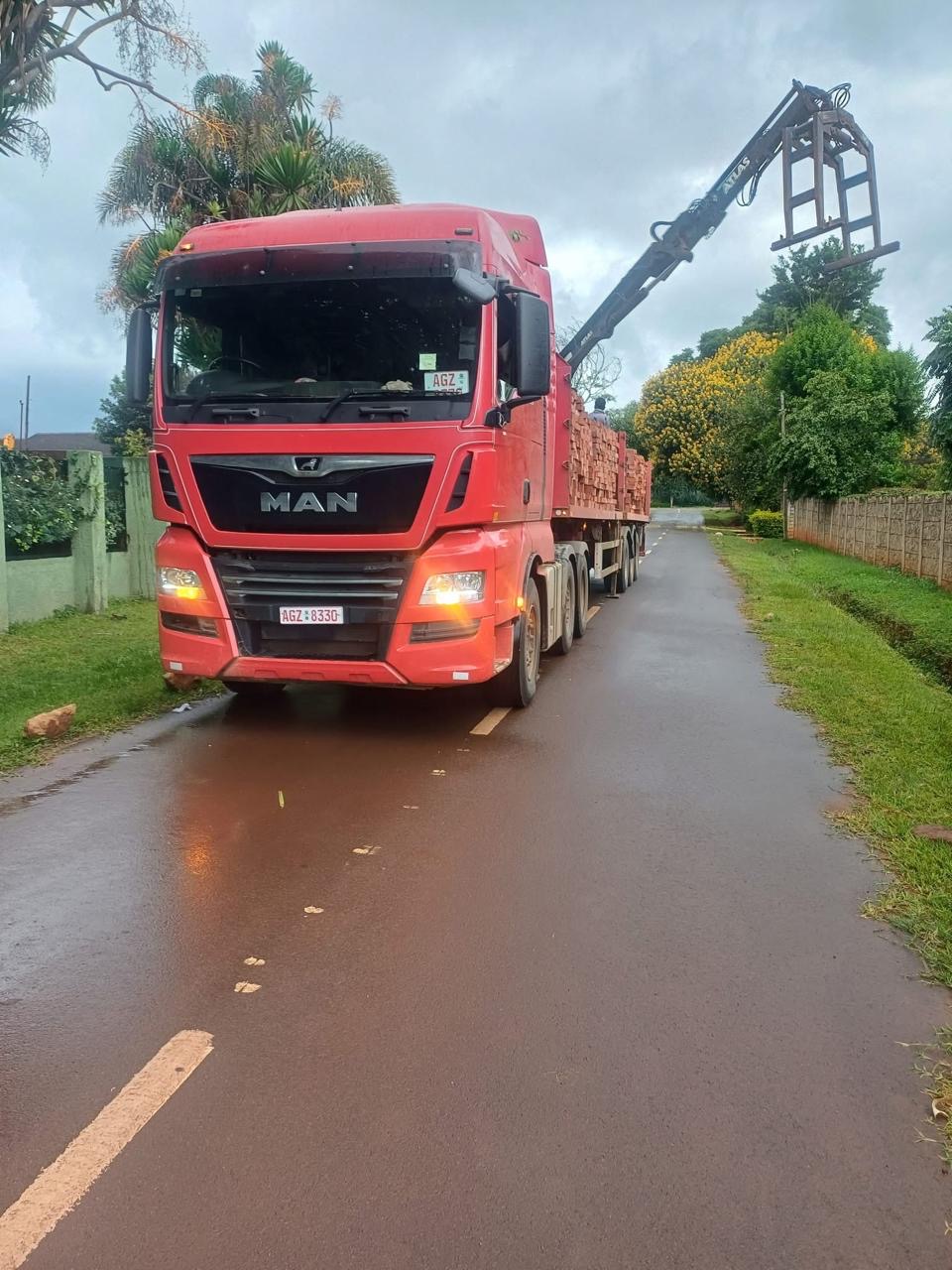 MAN grab truck with crane raised, loaded with bricks